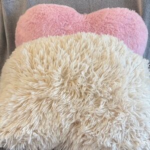 A Set of Two Fluffy Pillows; a Pink Heart & a Cream Square